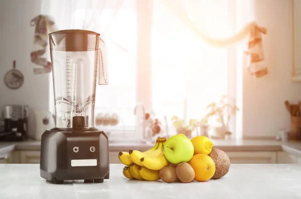 Blender, fruits and kitchen space. Sun flare