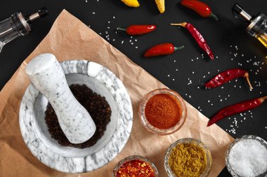 Çeşitli baharatlar ve kopya alanı siyah zemin üzerine harç