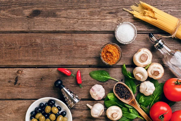 Italian food ingredients for the preparation pasta on wooden background