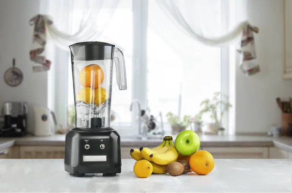 Blender and fruits on kitchen space — Stock Photo, Image
