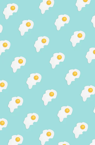 Broken egg on a light blue background — Stock Photo, Image