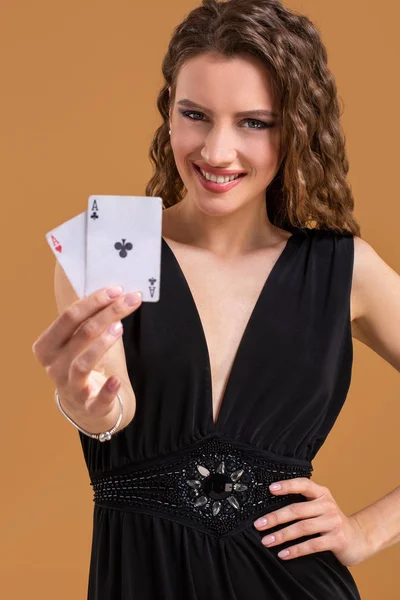 火かき棒ゲーム、ギャンブル、カジノのための印として 2 つの ace を保持している茶色の髪美人 — ストック写真