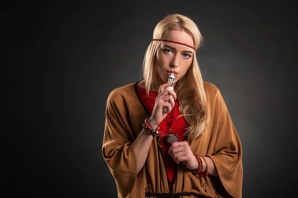 Portrait of sexy young hipster smoking vaping girl. The woman is dressed in the style of a boho. Vapor concept. Vaping e-Cigarette. — Stock Photo, Image