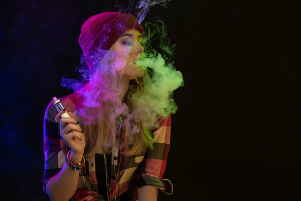 Dampfende Mädchen. junge Hipster-Frau vape e-cig auf Studio auf schwarzem Hintergrund. Hip-Hop-Stil. Nahaufnahme. — Stockfoto