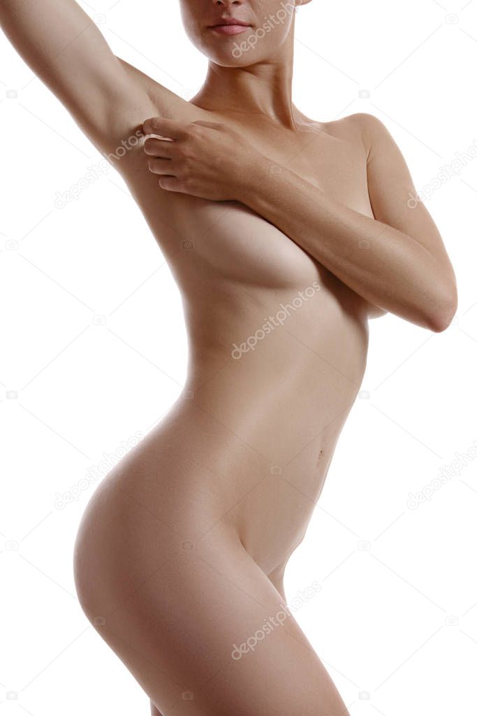 Perfect, nude body of a girl covering her breast with hands posing isolated on white. Plastic surgery and aesthetic cosmetology concept. Close-up.