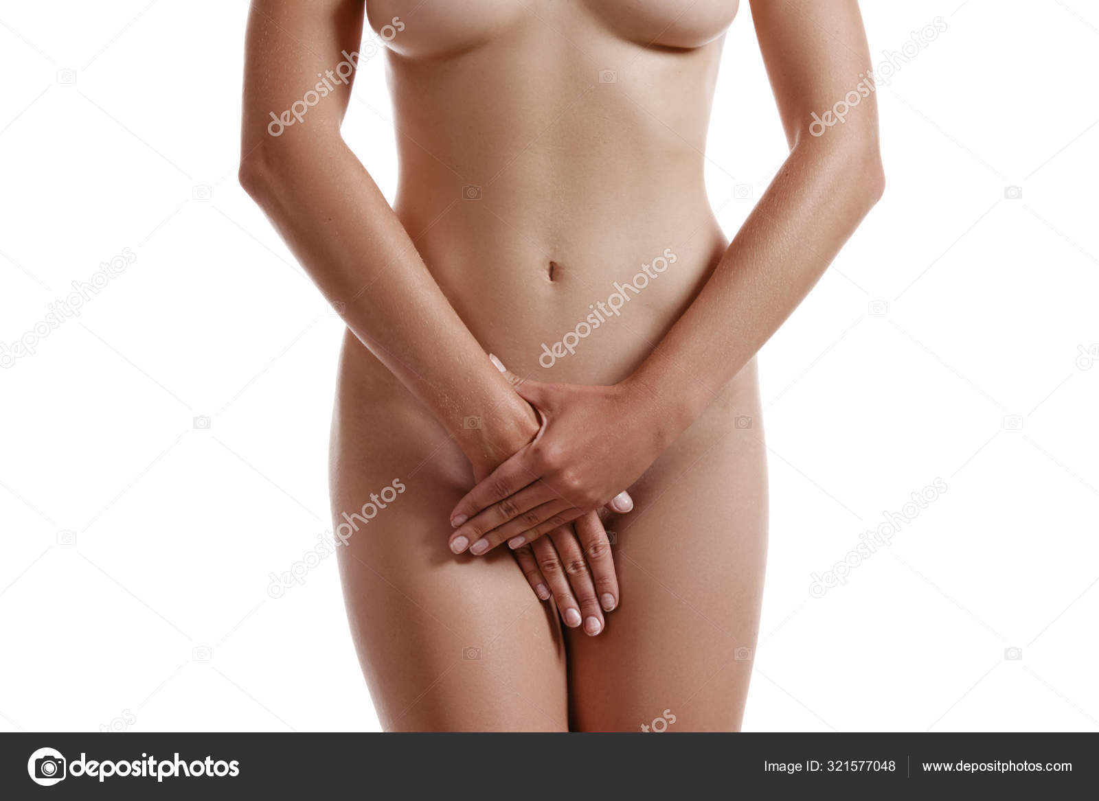 Beautiful nude brunette woman covering hear stock photo