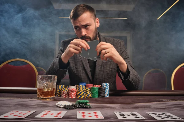Бородатый Человек Сером Костюме Играет Покер Сидя Столом Казино Дыму — стоковое фото