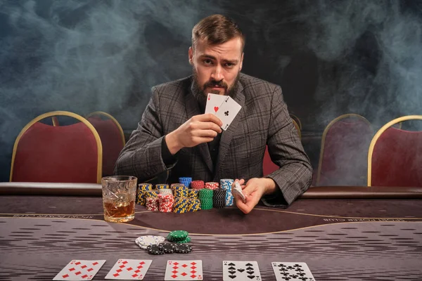 Γενειοφόρος Γκρι Κοστούμι Παίζει Πόκερ Καθισμένος Στο Τραπέζι Του Καζίνο — Φωτογραφία Αρχείου