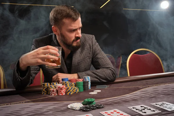 Premium Photo  Stylish bearded man in suit and scarf playing in dark casino