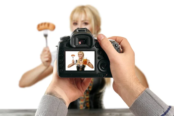 Digital single-lens reflex camera in hands. Photographer shooting hands close up. Man photographer makes photos for stock photography. Male hands hold the camera close-up