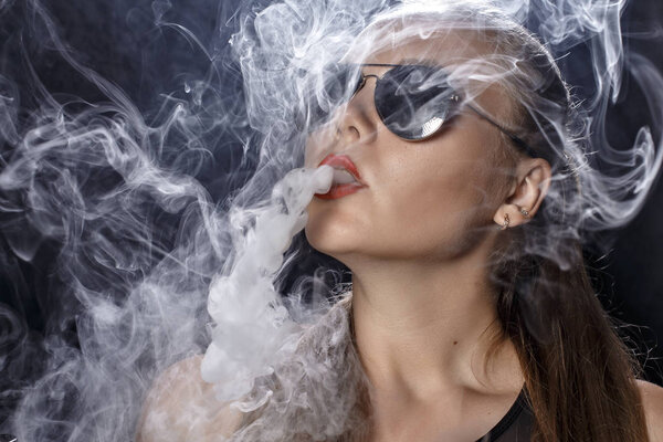 Girl soars on a black background vape