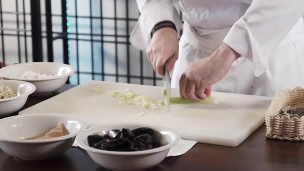 Proseffional chef hands is cutting celery on his own modern kitchen in slow motion 60fps — Stock Video