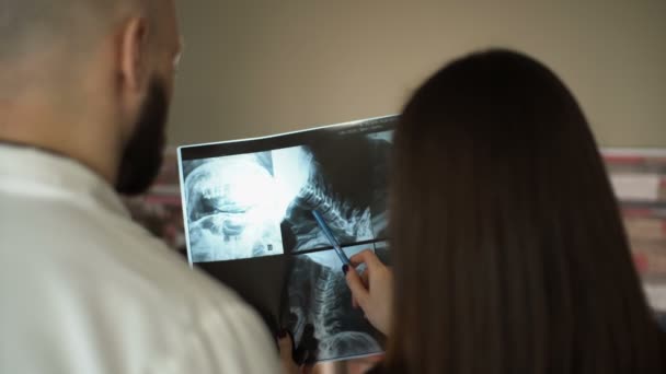 Медицинская команда, вместе изучающая рентген в больнице, обсуждает 4k — стоковое видео