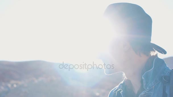 Hipster traveller is taking pictures on smart phone with sun flares — Stock Video
