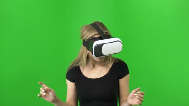 20s mujer rubia mirando en 3d panorama a través de gafas VR casco sobre fondo verde, croma key — Vídeo de stock