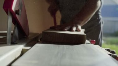 woodworker elinde yakından bir makine üzerinde ahşap tahta taşlama. güneş patlaması