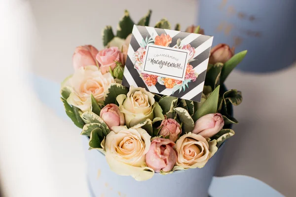 bouquet of spring flowers in box with greeting card