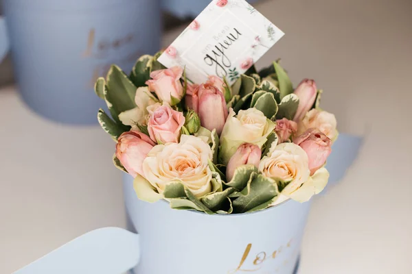 bouquet of spring flowers in box with greeting card