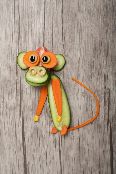 Funny monkey made of cucumber and carrot