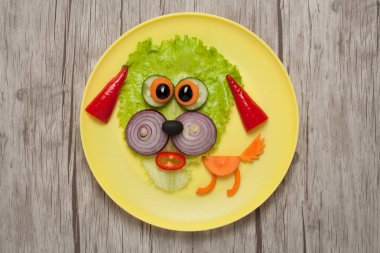 Plaka ve tablo üzerinde yapılan komik sebze köpek