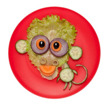Komik maymun salatalık ve salata plaka üzerinde yapılan