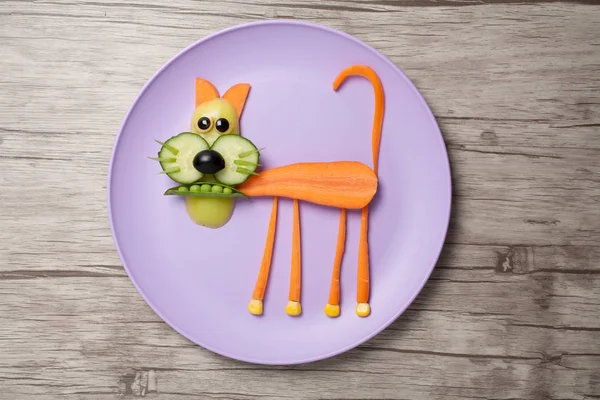 Kot z surowych warzyw na talerz i biurko — Zdjęcie stockowe