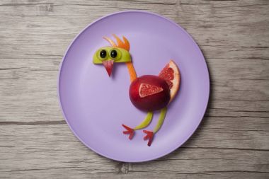 Ahşap arka plan üzerinde meyve ile yapılmış horoz