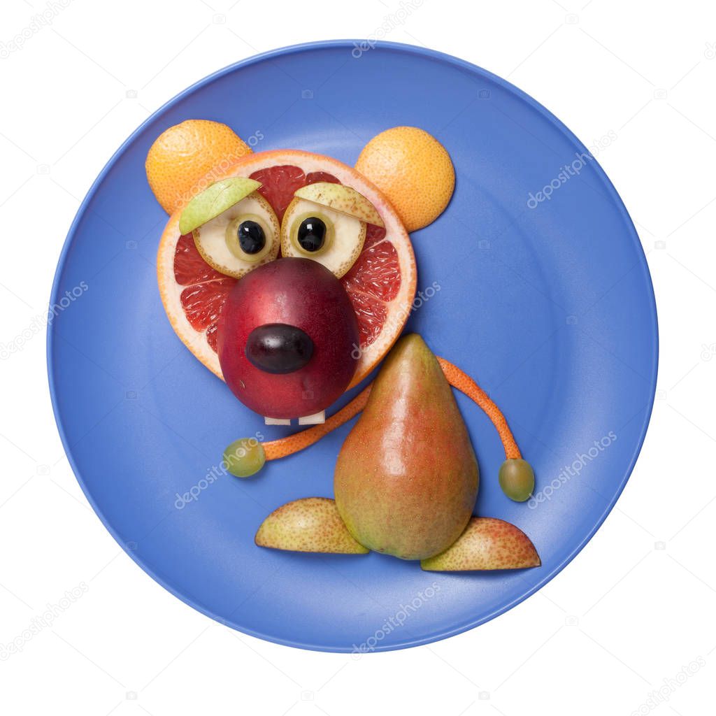 Bear made with fruits on blue plate