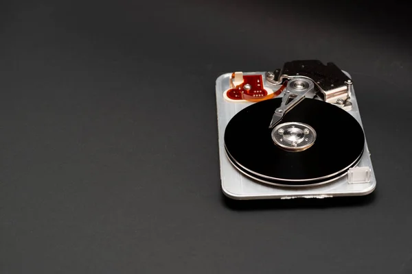 Disassembled hard drive on a dark background — Stock Photo, Image