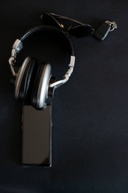 Kulaklıklar siyah arka planda akıllı telefon gözlükleri..