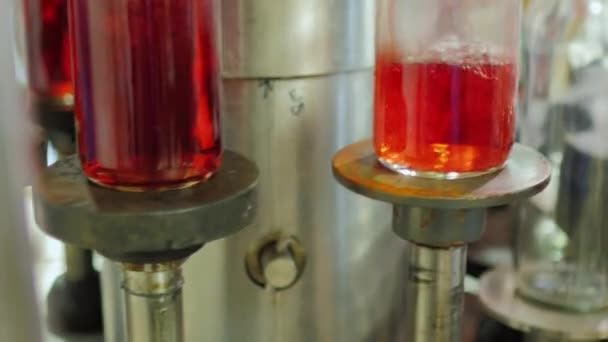 Nahaufnahme automatisierter Förderelemente durch Einschenken von Wein. Neigungskamera — Stockvideo