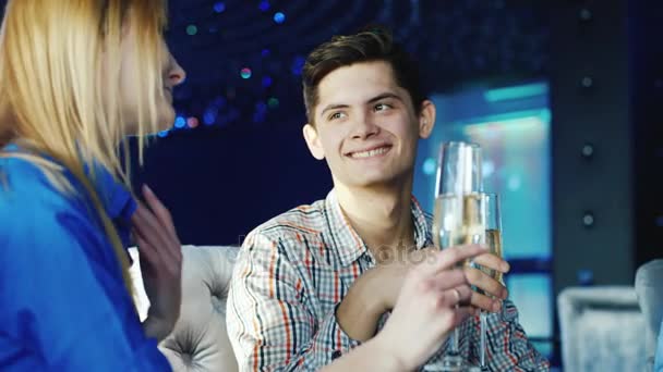 Young man in a restaurant drinking wine with friends. Also accepts congratulations — Stock Video