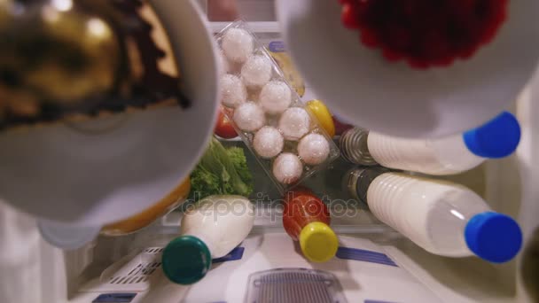 Timelapse: unloading Products from the refrigerator. Several shelves with different products are emptied - womens hands are taken one by one — Stock Video