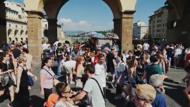 Florenz, italien, juni 2017: eine große menge von touristen auf der brücke über den arno. — Stockvideo