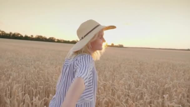 Atrás de você no campo de trigo, leve pela mão. Uma mulher lidera um parceiro — Vídeo de Stock