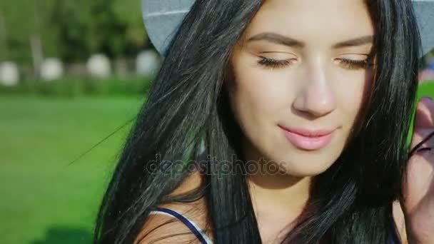 Portrait of young hispanic woman. Smiling, the wind plays with her long hair — Stock Video