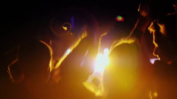 Woman with two teenage children having fun at a rock concert. Dancing and actively applauding — Stock Video