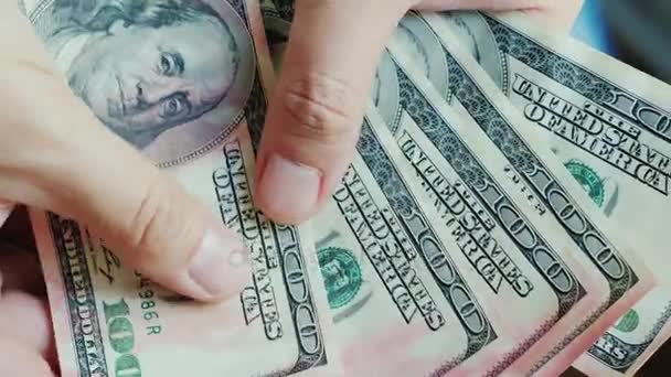 Mens vingers kijken naar Amerikaanse dollarbiljetten. Geld is beschadigd door roze verf — Stockvideo