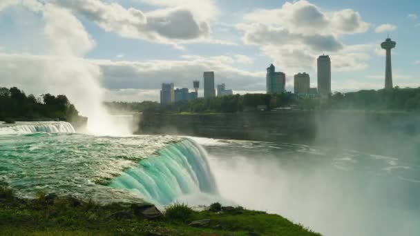 Niagara Falls, can be seen the Canadian coast and silhouettes of buildings on the other side of the Niagara River — Stock Video