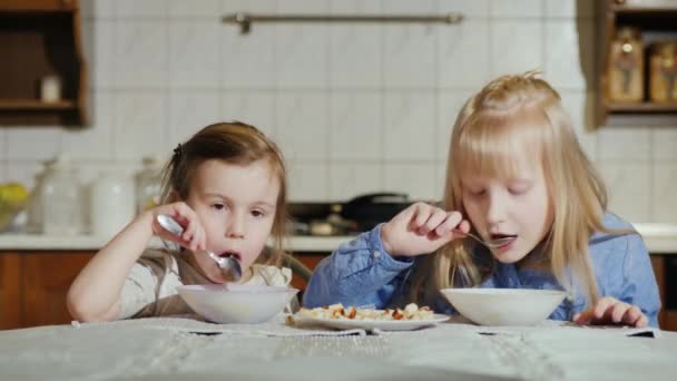 Dwie małe dziewczynki, 5 i 7 lat z apetytem zjeść zupę — Wideo stockowe