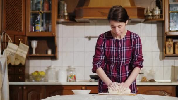 Uma mulher amassando massa de pizza em sua cozinha — Vídeo de Stock