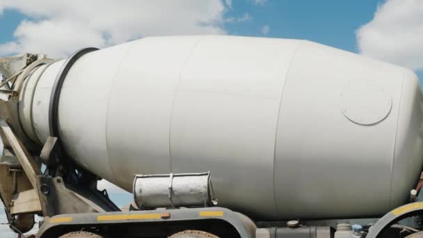 A large industrial concrete mixer, a tank with an ieton rotates against the sky. Concrete delivery and building materials concept — Stock Video