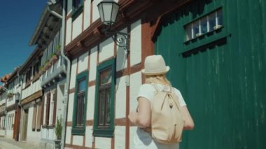 Bir kadın turist, şehrin güzel ve ıssız caddesinde yürümekten zevk alıyor. Arka plan