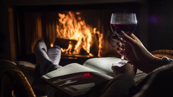 Sitting by the fireplace with a blank notebook and a glass of wine - planning a new life concept — Stock Photo, Image