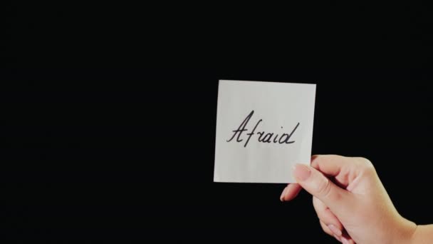 L'homme brûle un papier avec l'inscription Afraid — Video