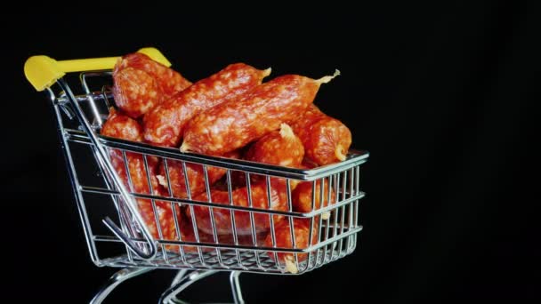 Sausages in a small trolley. Black background — 비디오