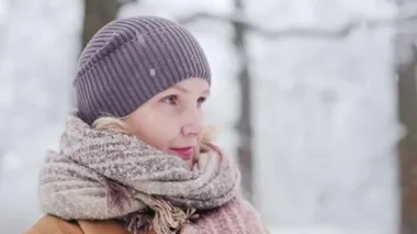 Side view of a middle-aged woman in a winter park