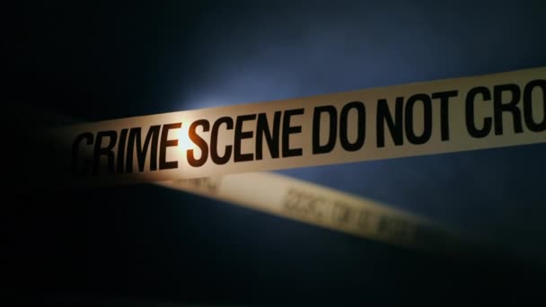 Tape encloses crime scene, refreshed by spotlight — Stock Video