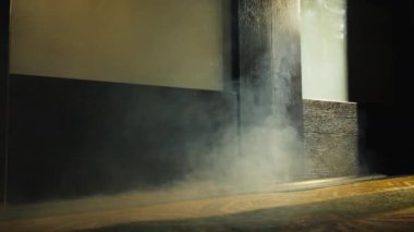 Smoke of fire coming from the cracks under the door in the room