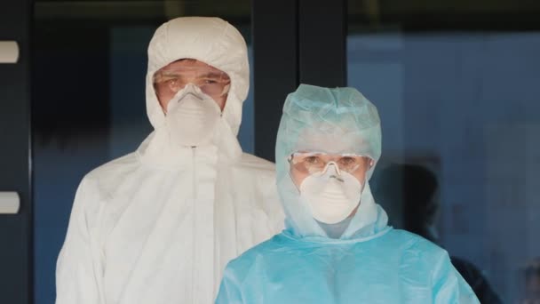 Medics show a hand gesture to Stop, dressed in protective clothing. Stop coronavirus — Stock Video